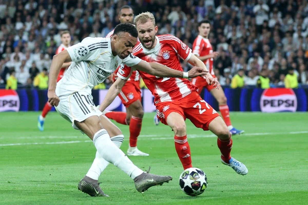 Kylian Mbappe dibayangi Konrad Laimer dalam pertandingan sepak bola leg pertama perempat final Liga Champions antara Real Madrid vs FC Bayern Muenchen di Stadion Santiago Bernabeu di Madrid pada 7 April 2026. (Foto oleh Pierre-Philippe MARCOU / AFP)(AFP/PIERRE-PHILIPPE MARCOU)